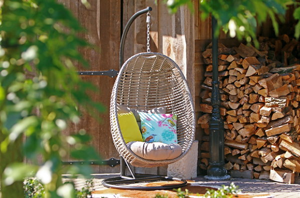 Natuurlijke Materialen in de Tuin met Houten Tuinmeubelen – Happy Swing Chair Hangstoel met Poot (Foto Kees Smit Tuinmeubelen op DroomHome.nl)