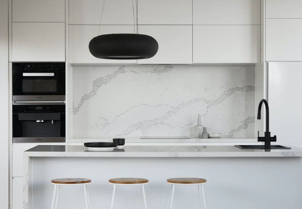 Witte keuken op maat met spoeleiland en marmerlook werkbladen en achterwand (Foto: R Architecture, Unsplash  op DroomHome.nl)